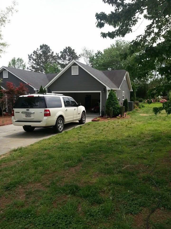 New Trane outdoor AC condenser installed on a level pad beside a Calhoun, GA home