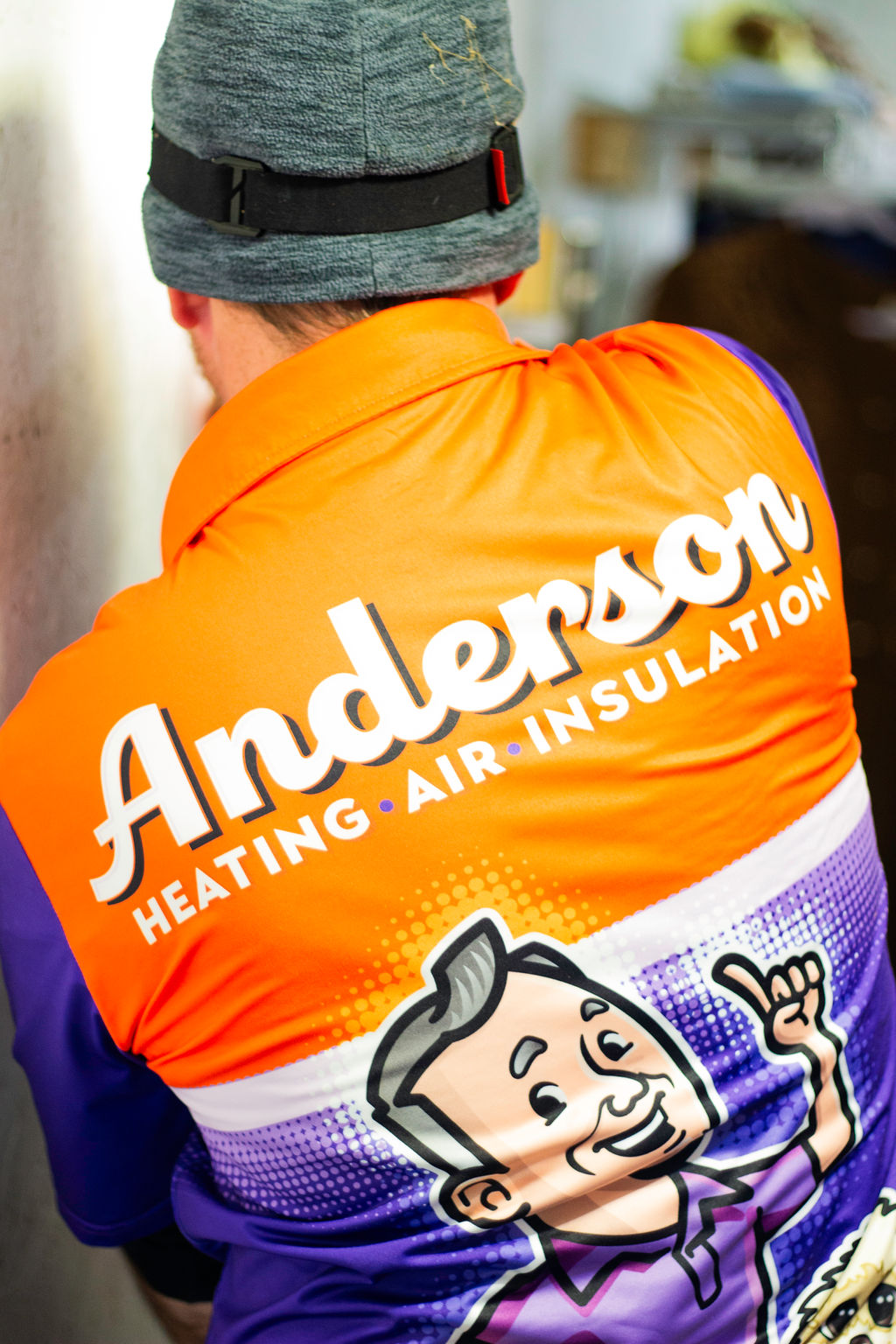Close-up of an Anderson Heating, Air & Insulation team member in branded Anderson Heating, Air & Insulation uniform with John Anderson mascot — Anderson serves Chatsworth and Murray County, GA.