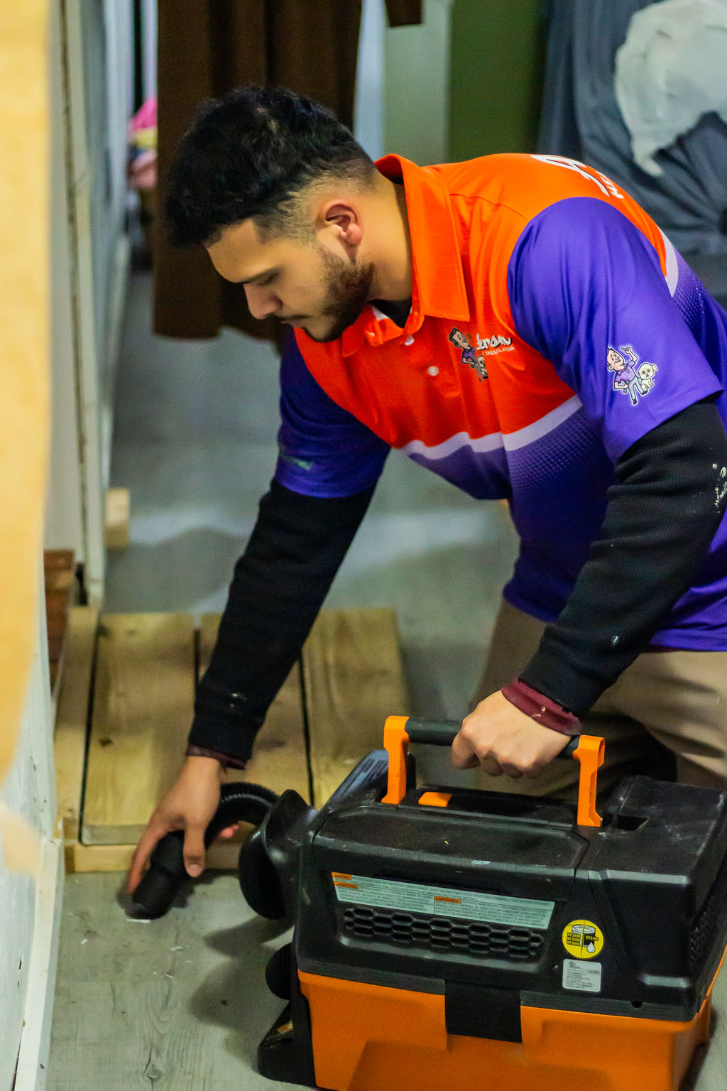 Anderson Heating, Air & Insulation technician with a shop vac in a residential service call — Anderson Heating, Air & Insulation serves Jasper and Pickens County, GA.