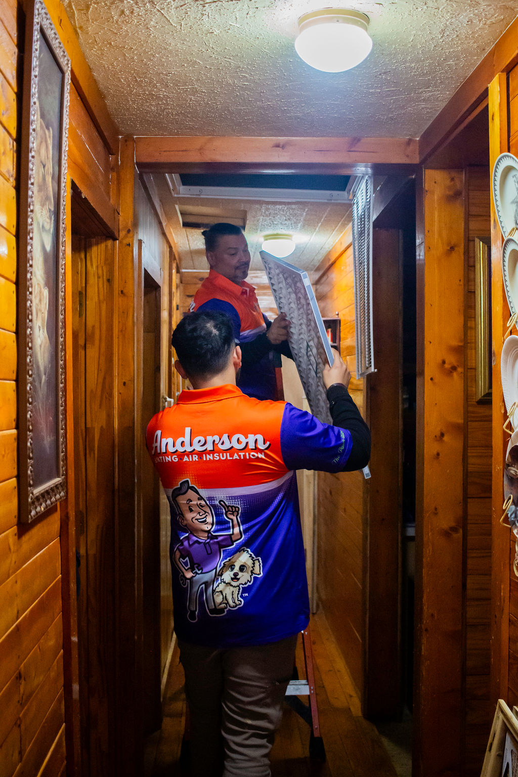 Anderson technicians handling a home HVAC air filter