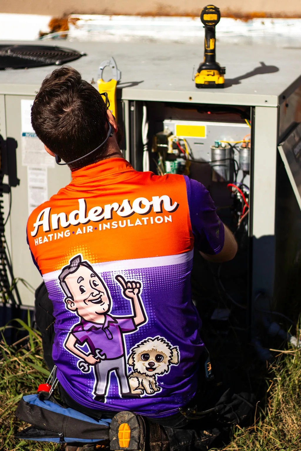 Anderson technician servicing an outdoor HVAC unit
