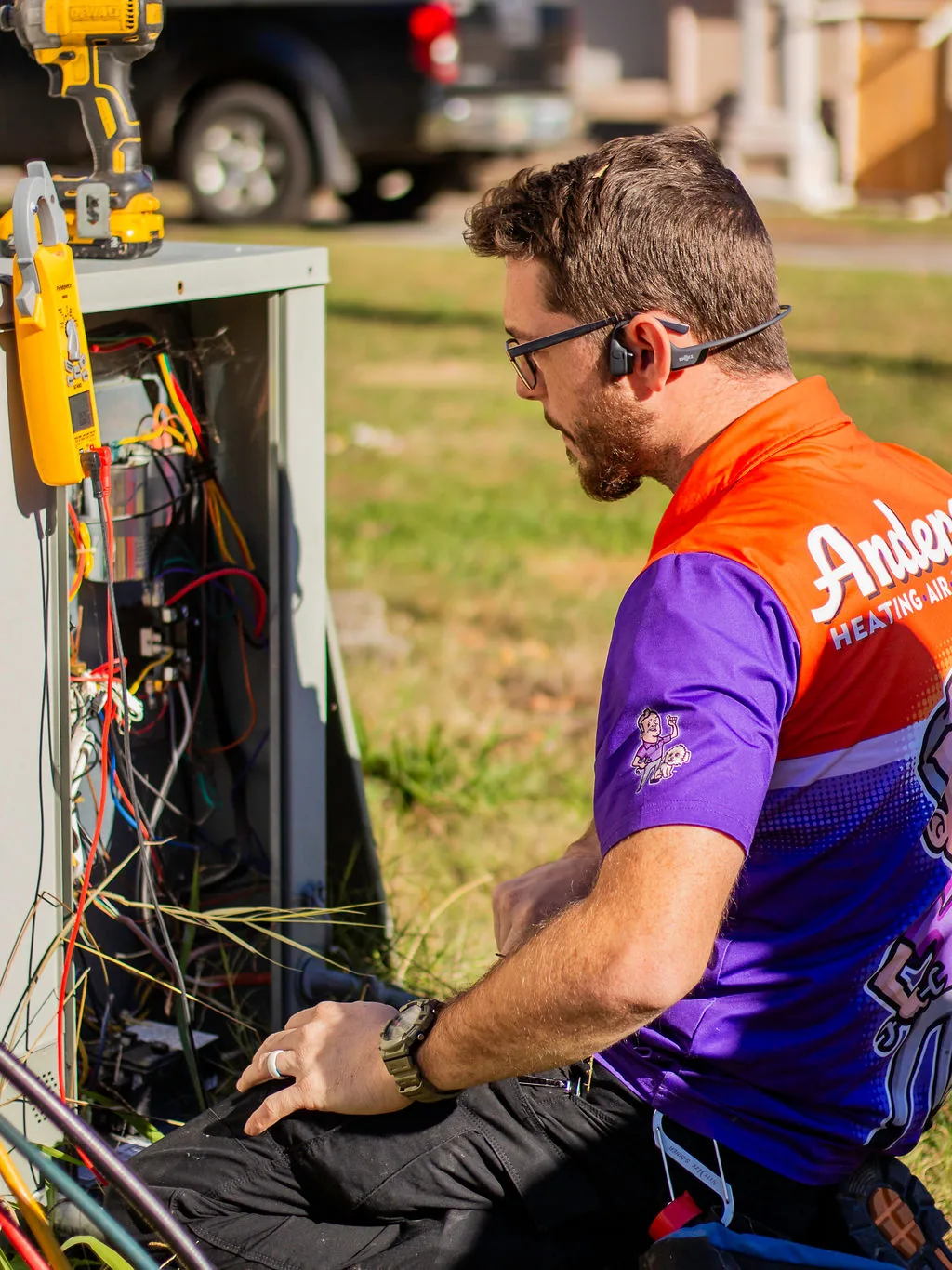 Anderson technician servicing an outdoor HVAC unit