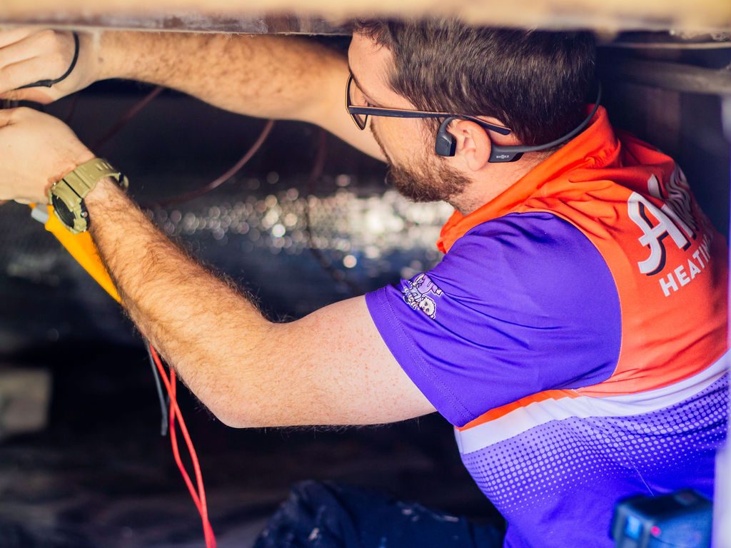 Anderson Heating, Air & Insulation technician with a Fluke meter, doing detailed diagnostic work — Anderson serves Rome and Floyd County, GA with BPI-certified HVAC diagnostics.