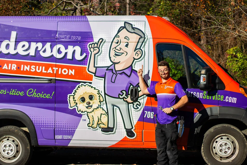 Anderson technician standing beside a branded Anderson service van