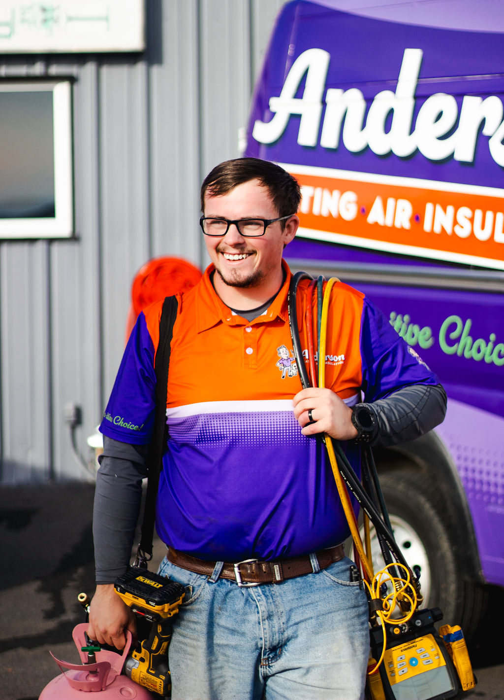 Anderson Heating, Air & Insulation technician with refrigerant gauges, vacuum pump, and recovery tank — the proper tools for installing or servicing a heat pump or ductless mini-split system in Northwest Georgia.