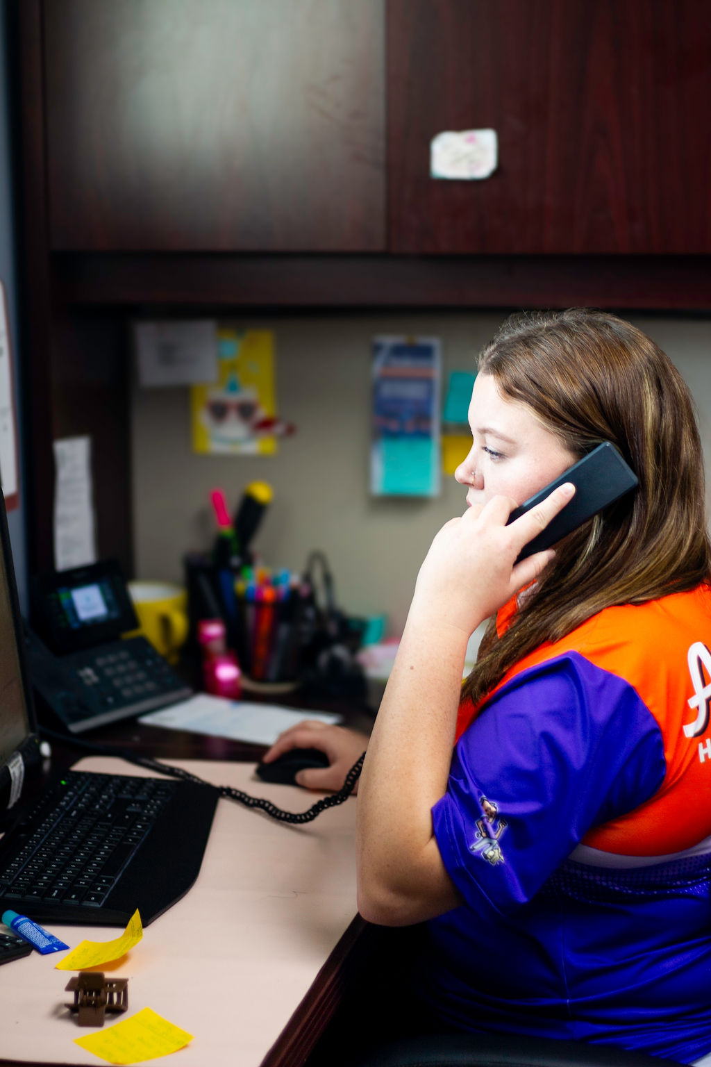 Anderson Heating, Air & Insulation office team member answering the phone at the company's Calhoun, Georgia headquarters — a real person picks up at (706) 629-0749, not a call center.