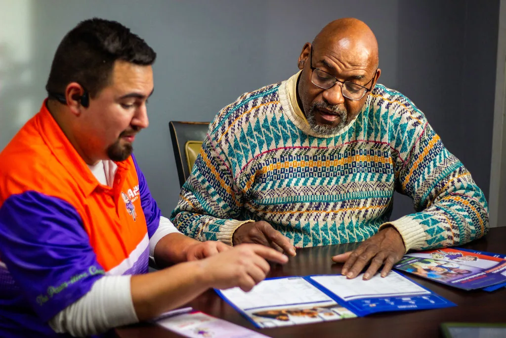 Anderson comfort advisor walking a homeowner through options and paperwork at the kitchen table