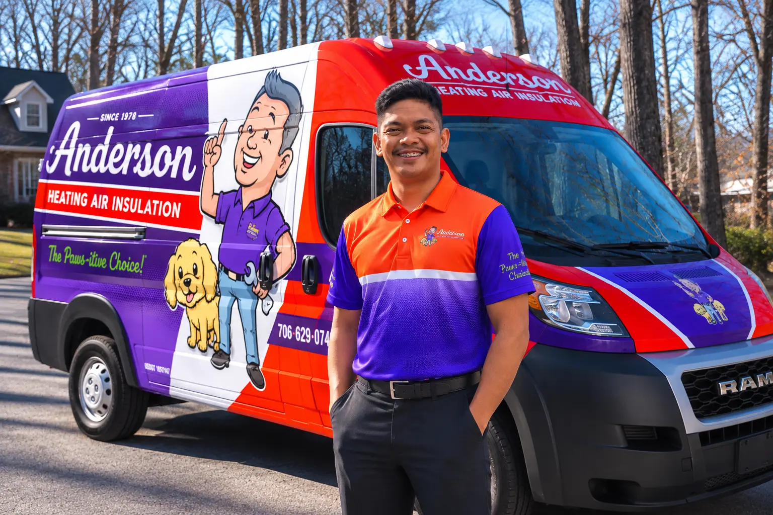 Smiling Anderson team member in an orange-and-purple Anderson polo standing in front of a wrapped Anderson service van