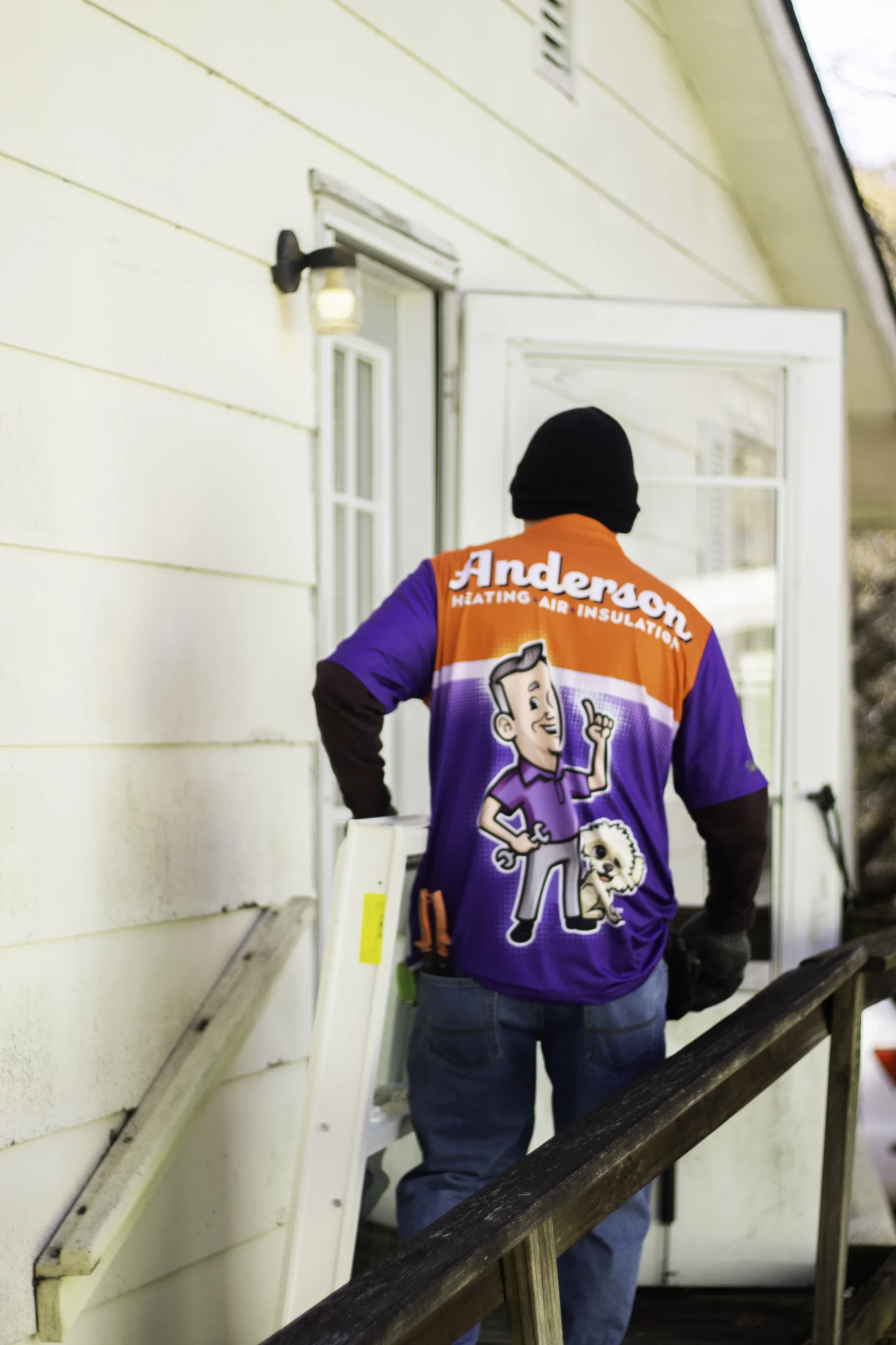 Technician installing replacement door in Calhoun GA home for improved energy efficiency and security.
