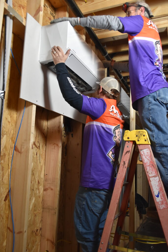 Anderson Heating technicians installing a ductless mini-split heat pump system in a Northwest Georgia home.
